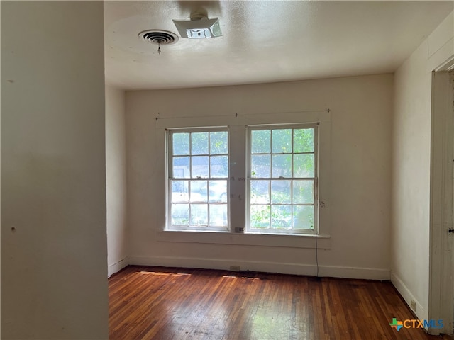 spare room featuring dark hardwood / wood-style flooring