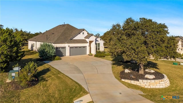 view of front of home featuring a front yard and a garage