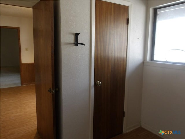 corridor featuring wood finished floors