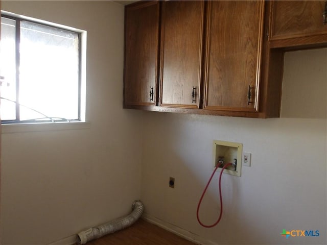 laundry area featuring hookup for a washing machine, cabinet space, and hookup for an electric dryer