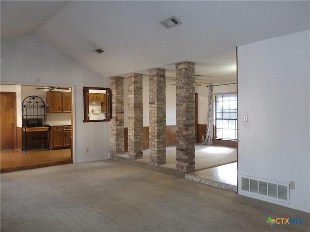 unfurnished living room with ceiling fan, carpet floors, visible vents, and ornate columns