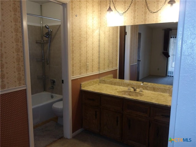 full bath featuring wainscoting, vanity, toilet, and wallpapered walls