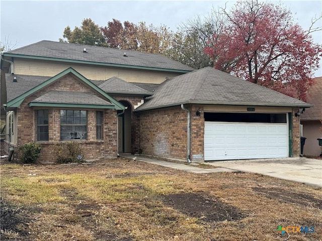 view of front of property with a garage and concrete driveway