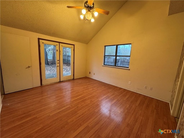 interior space with access to exterior, ceiling fan, wood finished floors, and french doors