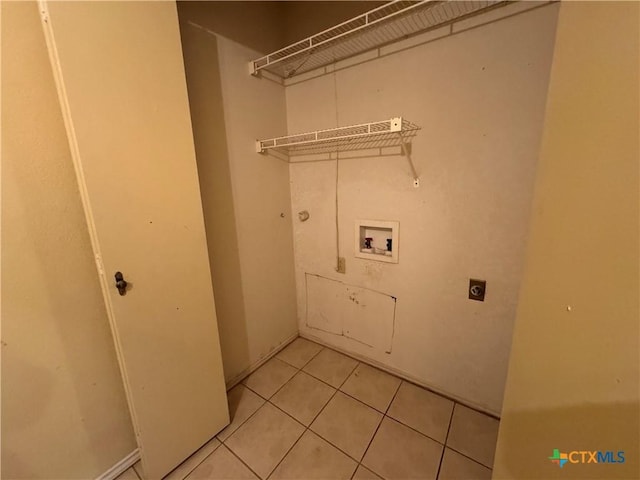 laundry room featuring hookup for a washing machine, light tile patterned floors, laundry area, and hookup for an electric dryer