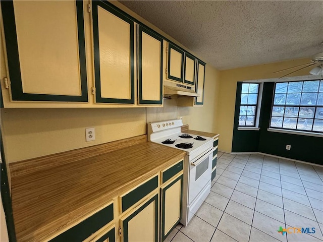 kitchen with light tile patterned floors, white range with electric stovetop, a ceiling fan, a textured ceiling, and under cabinet range hood