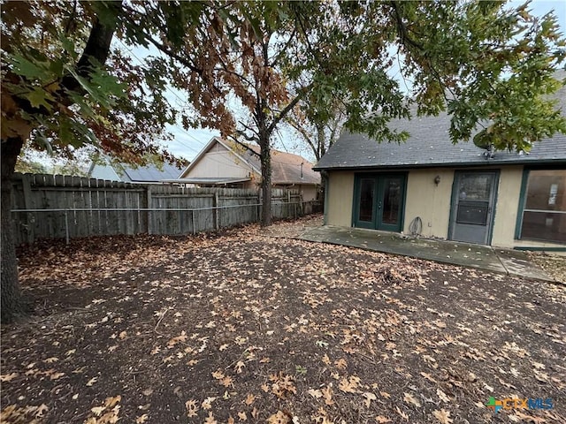 view of yard with french doors, a patio area, and fence private yard