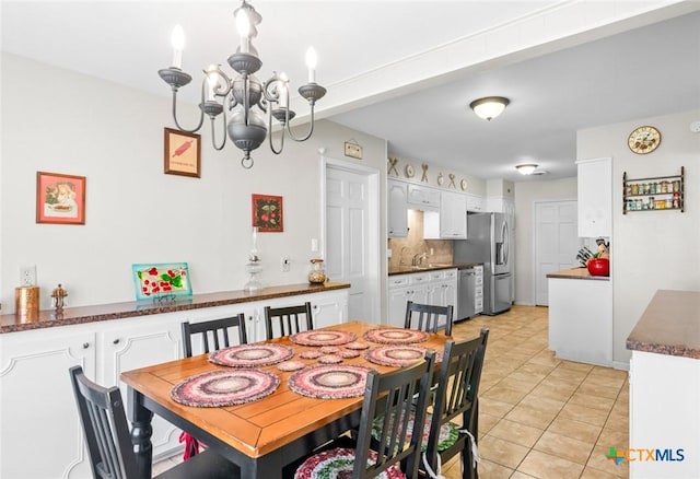 dining area featuring light tile patterned floors and a chandelier