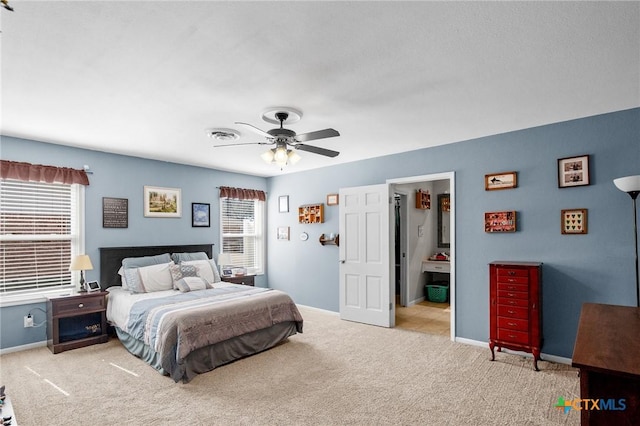 carpeted bedroom with baseboards, a ceiling fan, and visible vents