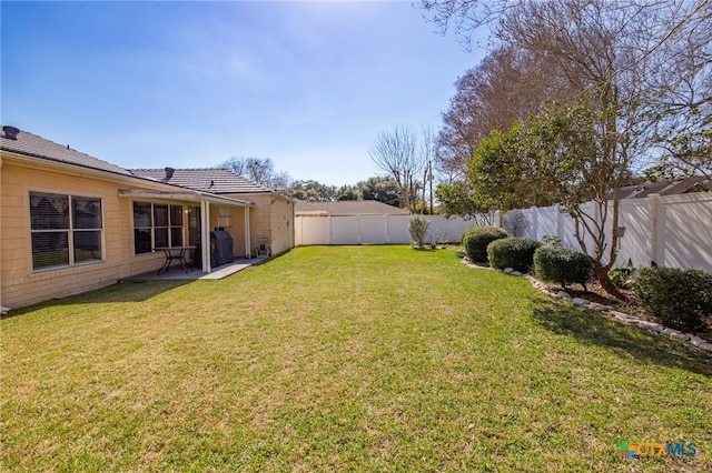 view of yard with a fenced backyard and a patio area