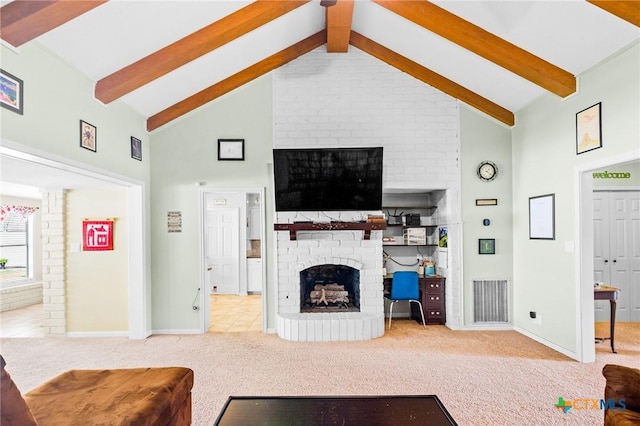 carpeted living area with visible vents, a brick fireplace, beamed ceiling, baseboards, and high vaulted ceiling