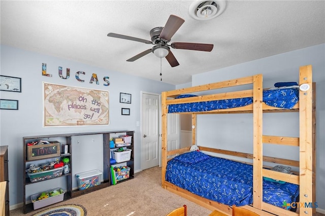 bedroom with visible vents, a ceiling fan, and carpet
