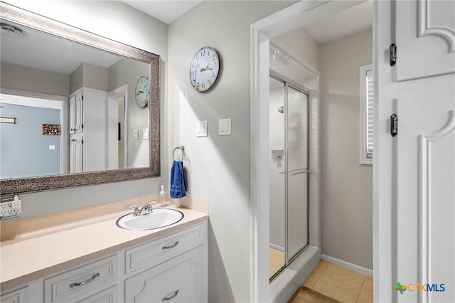 full bath with visible vents, tile patterned flooring, a stall shower, vanity, and baseboards