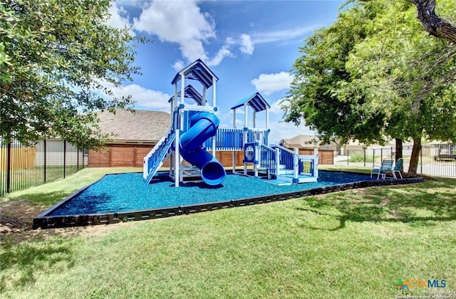 community jungle gym featuring fence and a yard