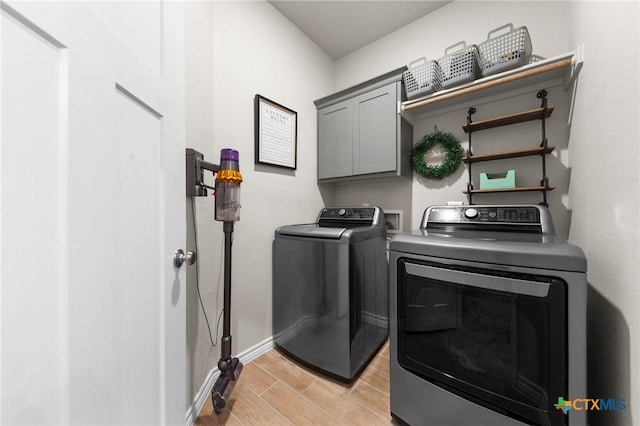 laundry room with cabinets and washing machine and dryer