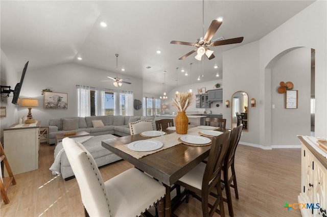 dining room featuring ceiling fan, lofted ceiling, and light hardwood / wood-style floors