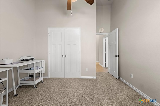 bedroom with ceiling fan, carpet flooring, and a closet