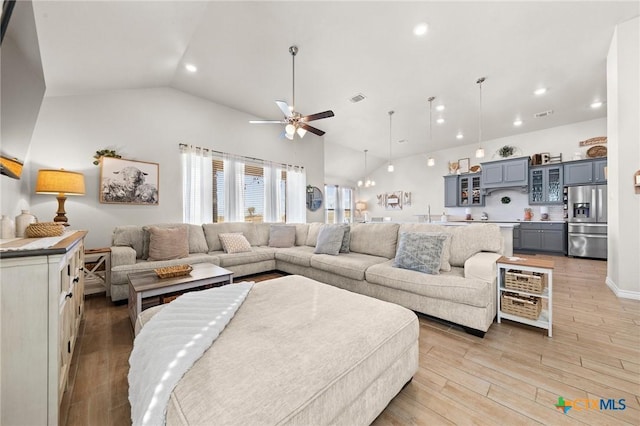 living room with vaulted ceiling and ceiling fan