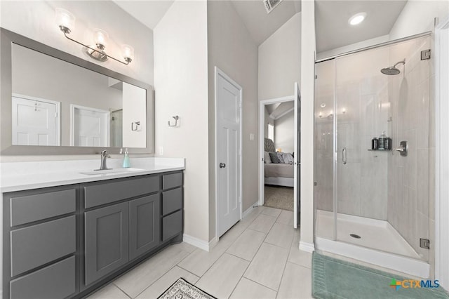 bathroom with vanity, a shower with shower door, and tile patterned floors