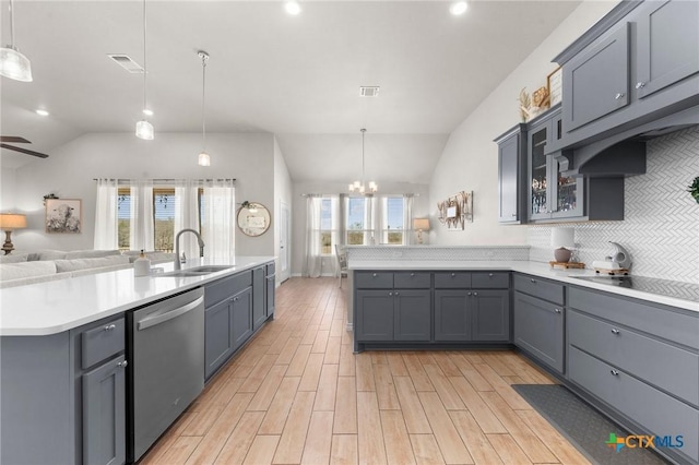 kitchen featuring gray cabinetry, sink, decorative light fixtures, and stainless steel dishwasher