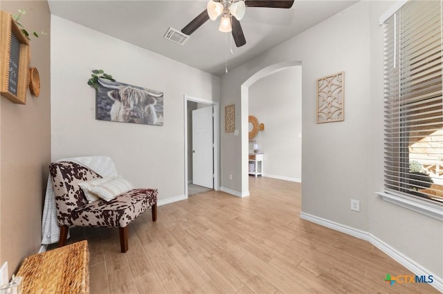 sitting room with ceiling fan and light wood-type flooring