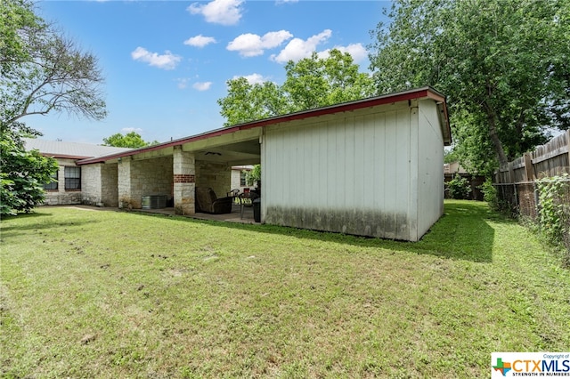 exterior space featuring an outbuilding and a lawn