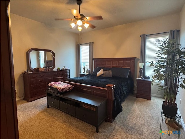 bedroom with light carpet and a ceiling fan