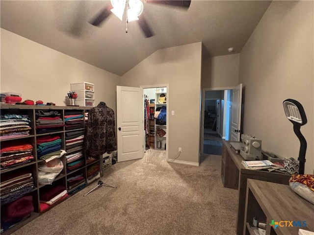 interior space with a ceiling fan, carpet, and vaulted ceiling