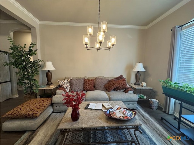 living area with baseboards, crown molding, a chandelier, and wood finished floors