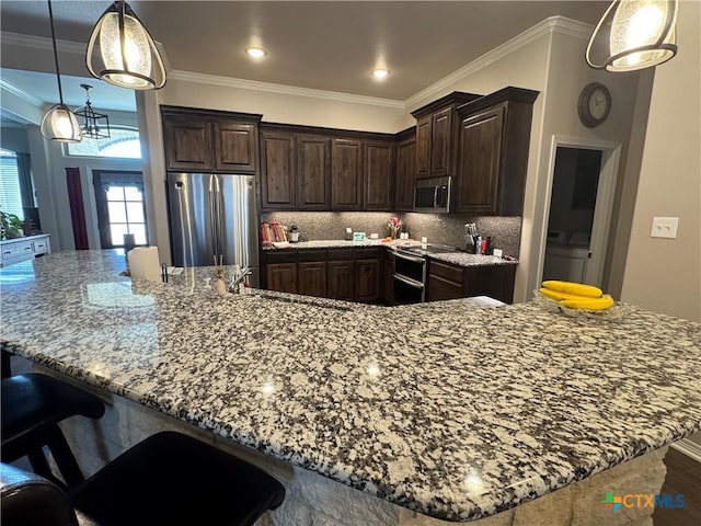 kitchen featuring ornamental molding, appliances with stainless steel finishes, washer / dryer, and tasteful backsplash