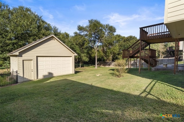 view of yard featuring a garage, an outdoor structure, and a deck