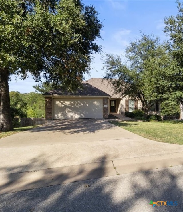 view of front of house featuring a garage and a front yard