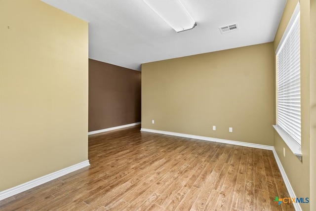 spare room featuring hardwood / wood-style flooring