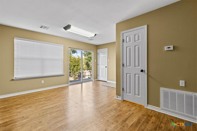 spare room featuring light hardwood / wood-style floors