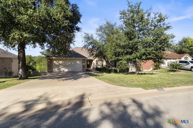 view of front of property with a garage and a front yard