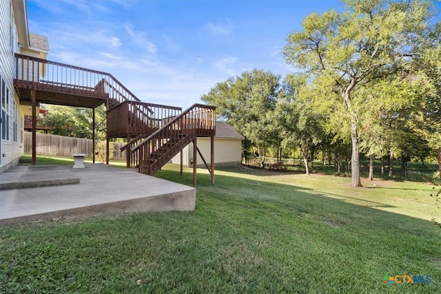 view of yard with a patio area and a wooden deck