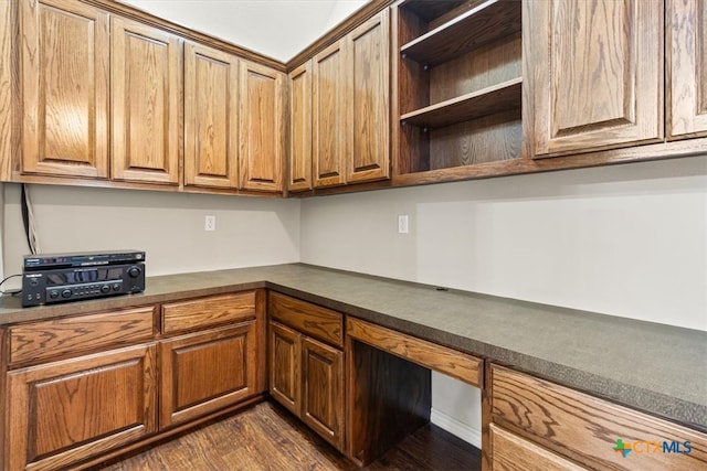 kitchen featuring built in desk and dark hardwood / wood-style floors