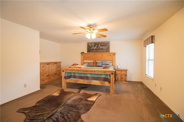 carpeted bedroom with a textured ceiling and ceiling fan