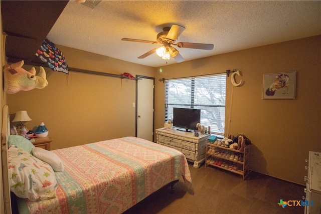 carpeted bedroom with ceiling fan and a textured ceiling