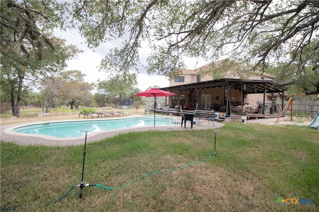 view of swimming pool with a yard and a patio area