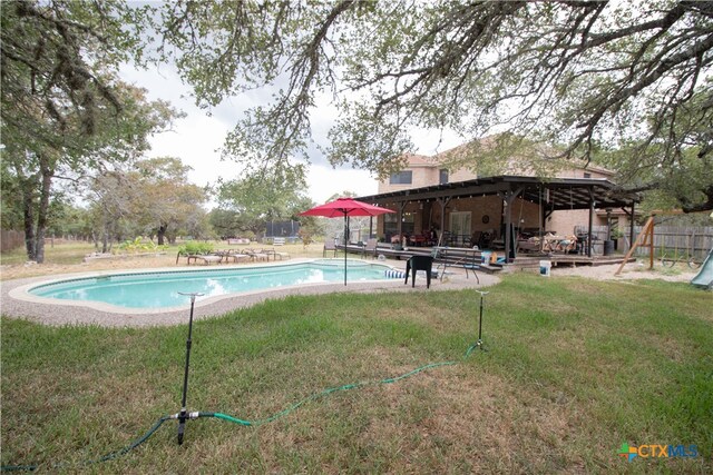 view of swimming pool with a yard and a patio area