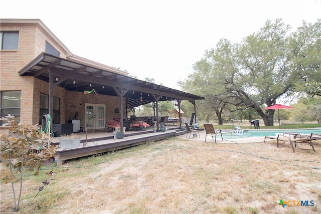 exterior space with french doors, a pergola, and a pool side deck