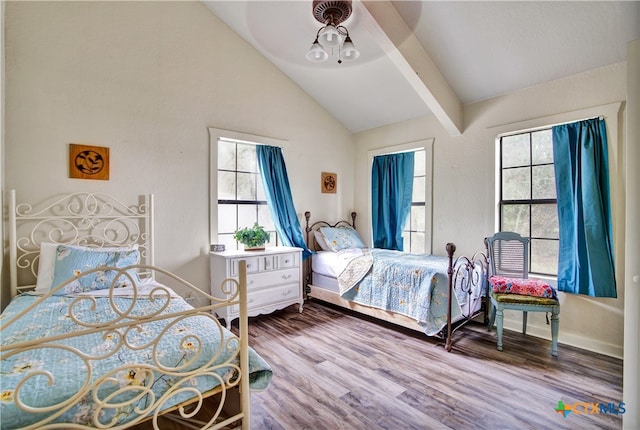 bedroom with lofted ceiling, baseboards, and wood finished floors