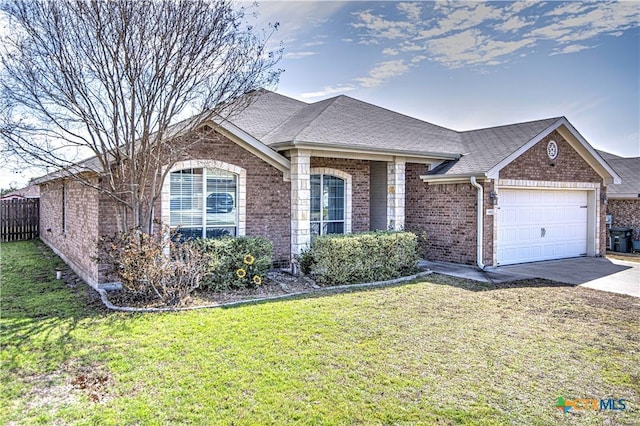 ranch-style home featuring a shingled roof, concrete driveway, an attached garage, a front lawn, and brick siding