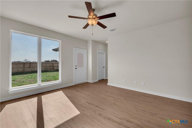 empty room featuring hardwood / wood-style flooring and ceiling fan