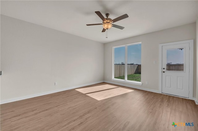 empty room with ceiling fan and hardwood / wood-style floors