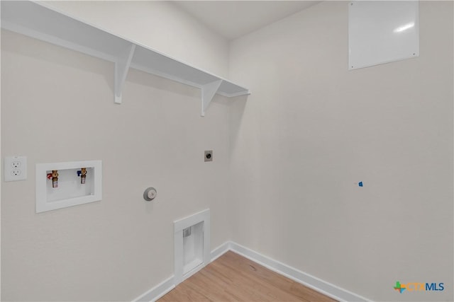 laundry room featuring electric dryer hookup, hookup for a washing machine, hardwood / wood-style flooring, and gas dryer hookup