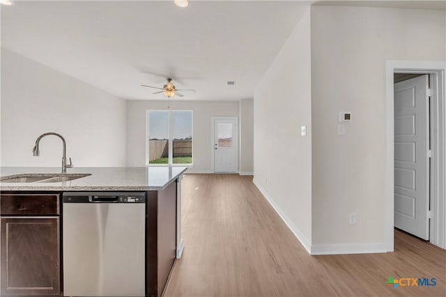 kitchen featuring dark brown cabinetry, sink, light hardwood / wood-style flooring, and stainless steel dishwasher