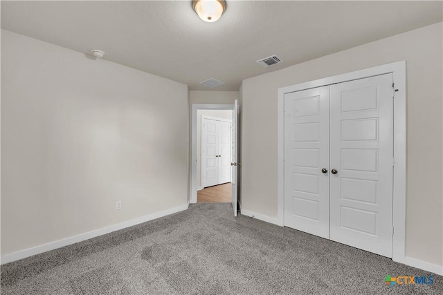 unfurnished bedroom featuring carpet floors and a closet