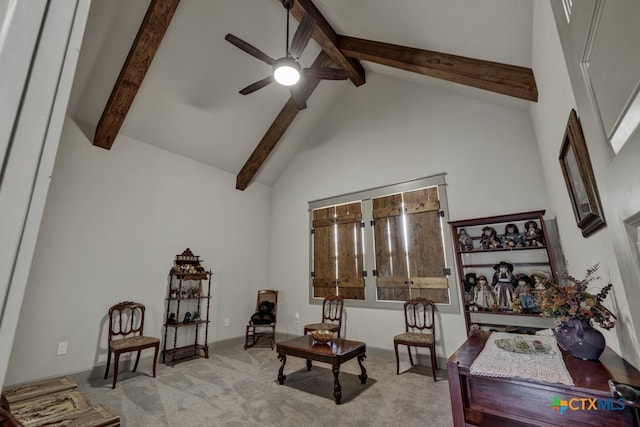 living area with high vaulted ceiling, light colored carpet, beamed ceiling, and ceiling fan